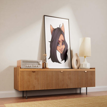 Baked Art - Furries Model 11 framed artwork with black-haired furry character, purple eyes, and a pink nose on modern wooden sideboard.