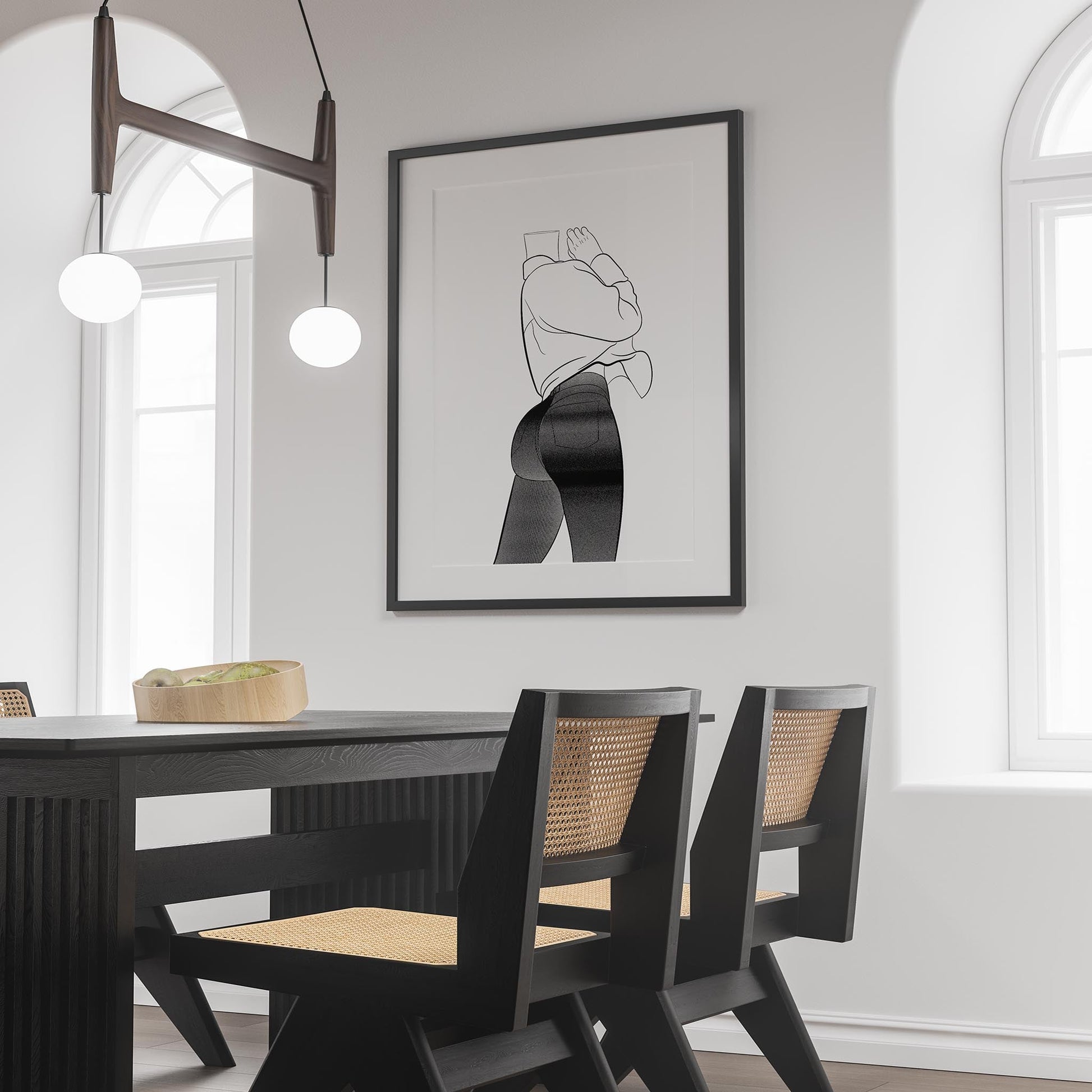 Line art of a person in jeans and a sleeveless top, framed on a wall in a modern dining room.