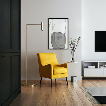Modern living room with yellow chair and framed line art of jeans on the wall.