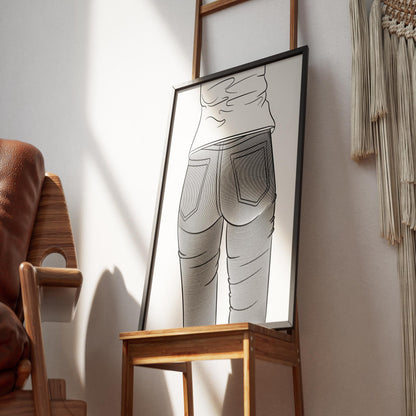 Framed line art of Jeans Denim Model 51 displayed on a wooden chair.
