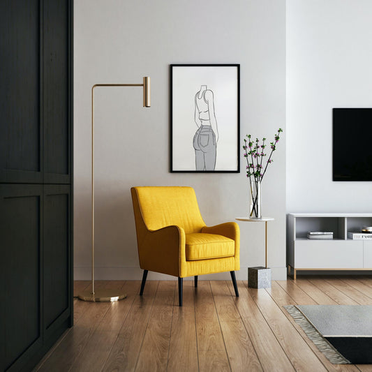Line art of a figure wearing jeans and a sleeveless top, emphasizing curves and denim texture, framed on a wall above a yellow chair.