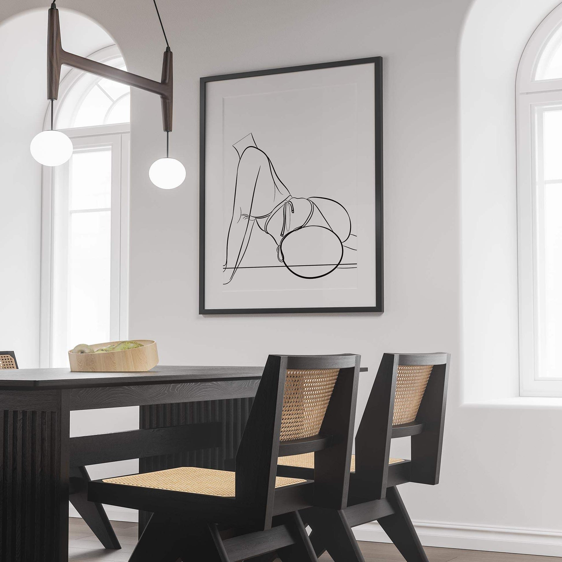 Framed digital artwork of a bikini model line art displayed in a modern dining room.